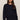 Woman wearing a navy blue sweater and pants on a beige background