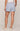 Light blue shorts worn by a person on a plain background