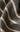 Close-up of textured fabric with beige lines on a dark background