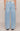Light blue jeans worn by a person on a beige background