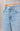 Light blue jeans with a beige background