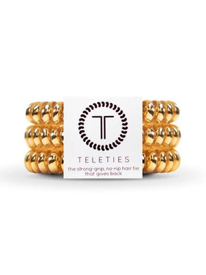 TELETIES - SMALL  - CHAMPAGNE GOLD - You can throw all your other hair ties away because these are the ultimate replacement to the traditional hair tie! It is like a hair tie and bracelet in one! Not only are they water-resistant, reduce damage to your hair, have a strong grip, and decrease creases, they also look good on your wrist! 